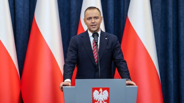 Prezydent Karol Nawrocki podczas oficjalnego wystąpienia na tle polskich flag