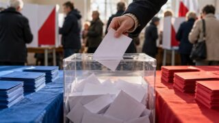 Urna wyborcza i karty do głosowania w lokalu wyborczym